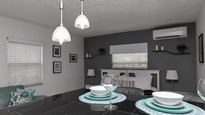 A modern dining area with a black marble table, white pendant lights, and a grey wall with an air conditioner and framed pictures. - 1bd 1bth , PYT , Airport , MPT (Fort Lauderdale)