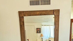 A room with a large mirror, a door, a lamp, a bed, and a rug. - Fort Huachuca. Home with private Gym. Pet with fee (Sierra Vista)