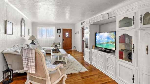 A living room with a sofa, a chair, a television, and a cabinet. - Central El Paso. 7 mins to Ft Bliss. (El Paso)