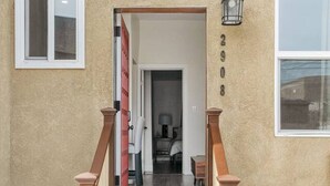 A wooden staircase leading to a door with a number '2908' above it.