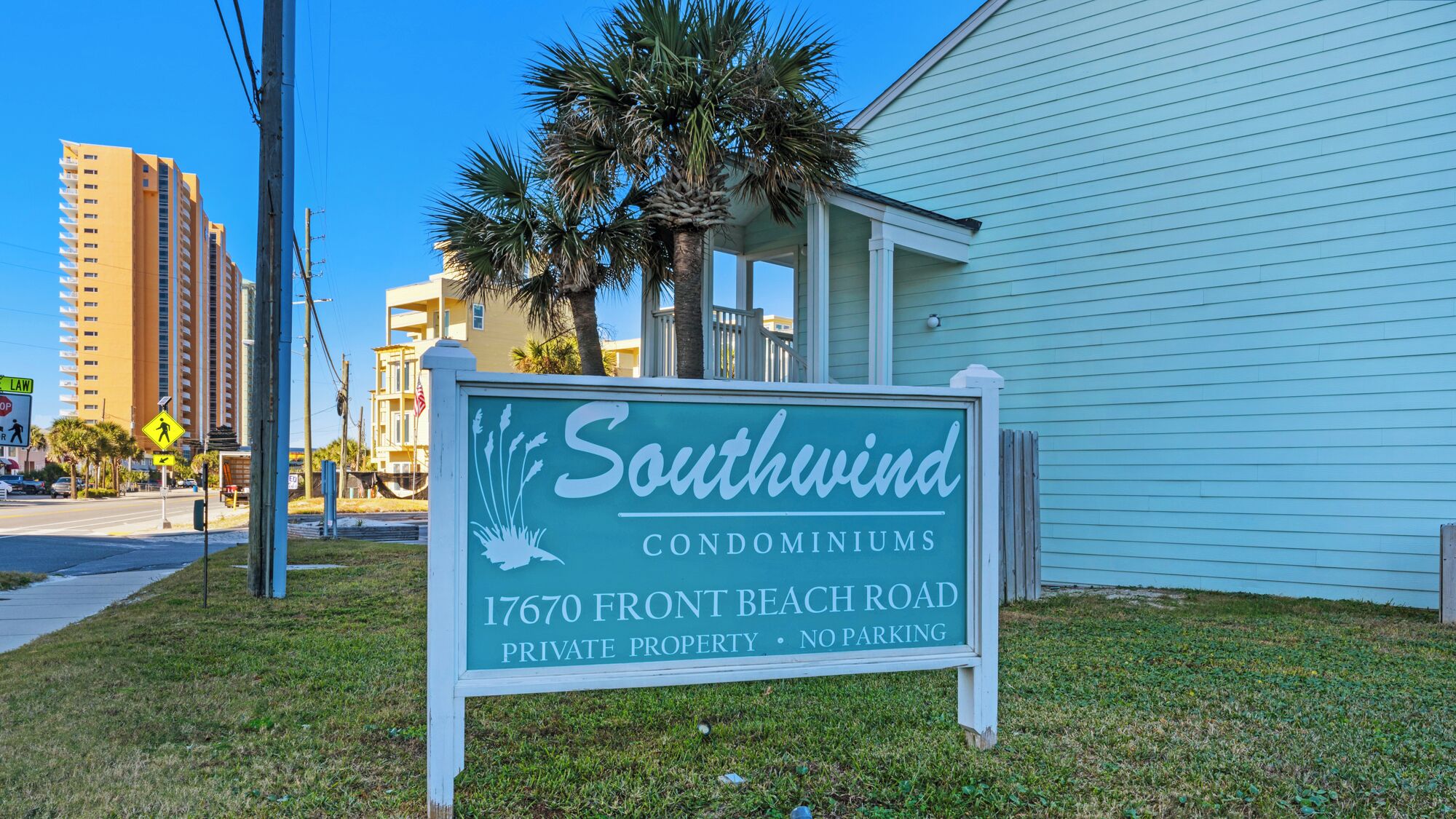 A sign for Southwind Condominiums at 17670 Front Beach Road, indicating it is private property with no parking.