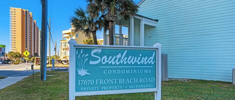 A sign for Southwind Condominiums at 17670 Front Beach Road, indicating it is private property with no parking.