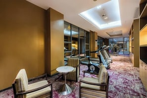 A hotel lounge with seating, a treadmill, and a large window. - Longdu Jingyi International Resort Hotel （Ethnic Culture Park Branch） (Kaili)