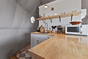 Fridge, microwave, coffee/tea maker, cookware/dishes/utensils