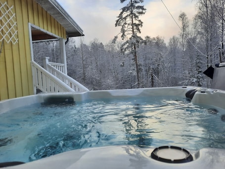 Outdoor spa tub. private wellness house med private outside jacuzzi, sauna, massagechair and gym