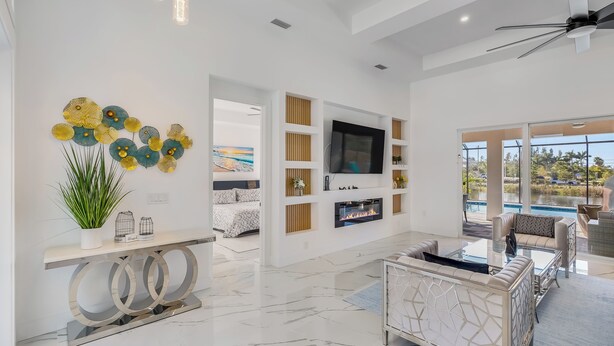 A modern living room with a TV, fireplace, and seating area.