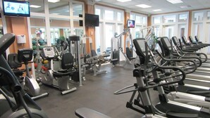 A gym with various exercise machines, mirrors, and large windows. - Beach Club D1606- K/Q/TwTwTwTw -Direct Gulf View  Beach  Pool - sleeps 8 in beds (Gulf Shores)