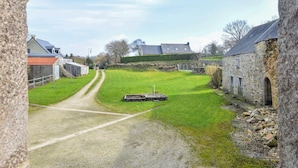 A rural road leading to a stone house with a grassy yard and a small pond. - Lovely apartment in Saint-Christophe-du-Fo (Saint-Christophe-du-Fo)