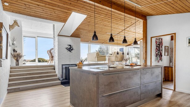 A modern kitchen with a large island, wooden ceiling, and pendant lighting. - Gorgeous home in Hals with WiFi (Hals)