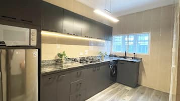 Deluxe Apartment, 3 Bedrooms, Private Bathroom, Courtyard View | Private kitchen | Dining tables