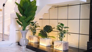 A modern lobby with a marble floor, a staircase, and potted plants. - ABOT Luxury Homes (Lekki, Lagos State)