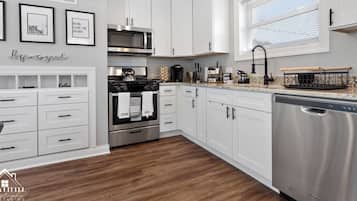 Fridge, microwave, coffee/tea maker, cookware/dishes/utensils