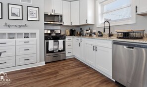 Fridge, microwave, coffee/tea maker, cookware/dishes/utensils