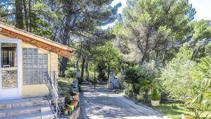 A stone building with a tiled roof and a staircase leading to a door. - Air-conditioned villa in the Luberon countryside, with fenced pool, pets allowed (2). (LIOUX)