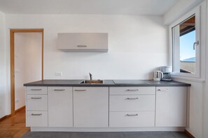 Fridge, stovetop, dishwasher, coffee/tea maker