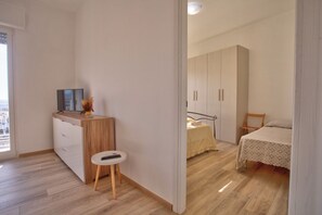Une chambre à coucher comprenant un lit, une table de chevet, une chaise et une armoire.