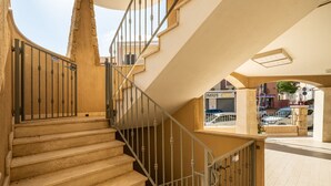 A staircase with a metal railing leading to an upper floor.