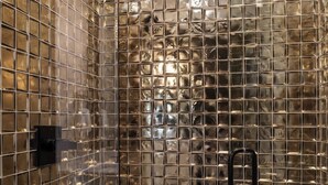 A shower with a glass enclosure and a handheld showerhead. - French’s Loft | Luxe Stay Near Broadway (Nashville)