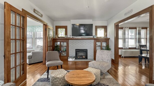 A spacious living room with a fireplace, comfortable seating, and a television. - Beach Bungalow, walk to beach, private backyard (West Haven)