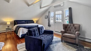A bedroom with a bed, a chair, a rug, and a ceiling fan. - Beach Bungalow, walk to beach, private backyard (West Haven)