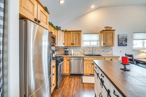 A modern kitchen with wooden cabinets, stainless steel appliances, and a wooden countertop. - Hike, Ski & Explore: Fraser Townhome w/ Hot Tub! (Fraser)