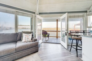 Relax on the sofa near the large window, or enjoy the view from the deck with a rocking chair and bar stools.