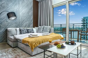 Signature Apartment, Balcony, Canal View | Living area | 63-inch Smart TV with digital channels, Netflix, streaming services