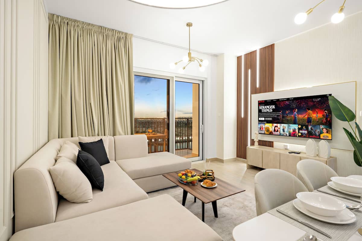 A modern living room with a sofa, coffee table, and dining area.