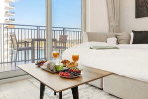Elite Apartment, Balcony, Canal View | Living area | 63-inch Smart TV with digital channels, Netflix, streaming services - Desert Key - Perfectly Located Yas Island Premier Apts (Abu Dhabi)