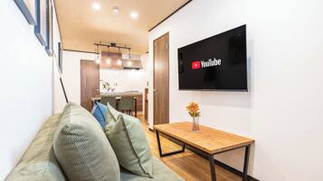 Comfort House | Living area | 50-inch flat-screen TV with cable channels