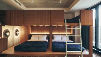 A modern bedroom with a bunk bed, wooden paneling, and a checkered rug.
