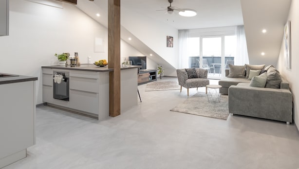 A modern apartment with a kitchen, living area, and balcony. - Apartment 'Exklusive "DG"' with Lake View, Balcony and Wi-Fi (Konstanz)