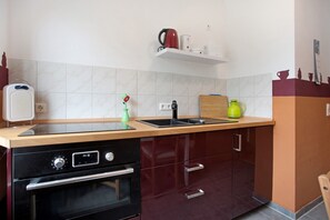 A kitchen with a built-in oven, a sink, and a countertop.