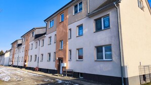 A multi-story residential building with a flat facade, multiple windows, and a visible entrance. - Apartment 'Meer-Natur-Idyll' with Wi-Fi (Peenemünde)