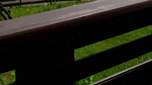 A bench overlooking a rural landscape with a clear sky and distant hills. - Cozy Log Cabin in the Harz with Private Terrace & Garden (Bad Sachsa)