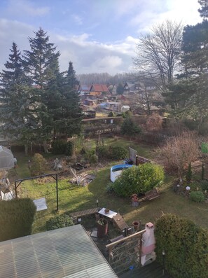 A residential area with houses, a garden, and a pond.