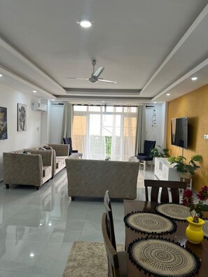 Deluxe Apartment, Balcony, City View | Living area | 32-inch Smart TV with digital channels - Lux Suites Aqua Gardens Nyali (Mombasa)