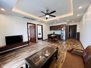 Family Apartment, 2 Bedrooms | Living area | 43-inch TV with cable channels