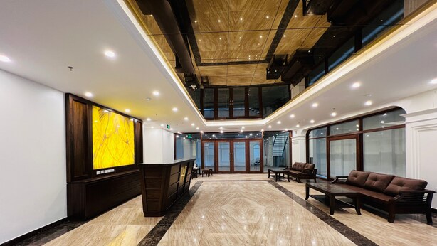 A spacious lobby with a reception desk, seating area, and a staircase leading to an upper level. - Hanoi Apartment  (Hanoi)