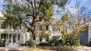 A two-story house with a balcony, surrounded by trees and a driveway. - The Preserve | Barbados Lock-off | 3 BR + 3 BA (Charleston)