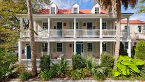 A two-story building with a balcony, columns, and a red roof. - The Preserve | Barbados Lock-off | 3 BR + 3 BA (Charleston)