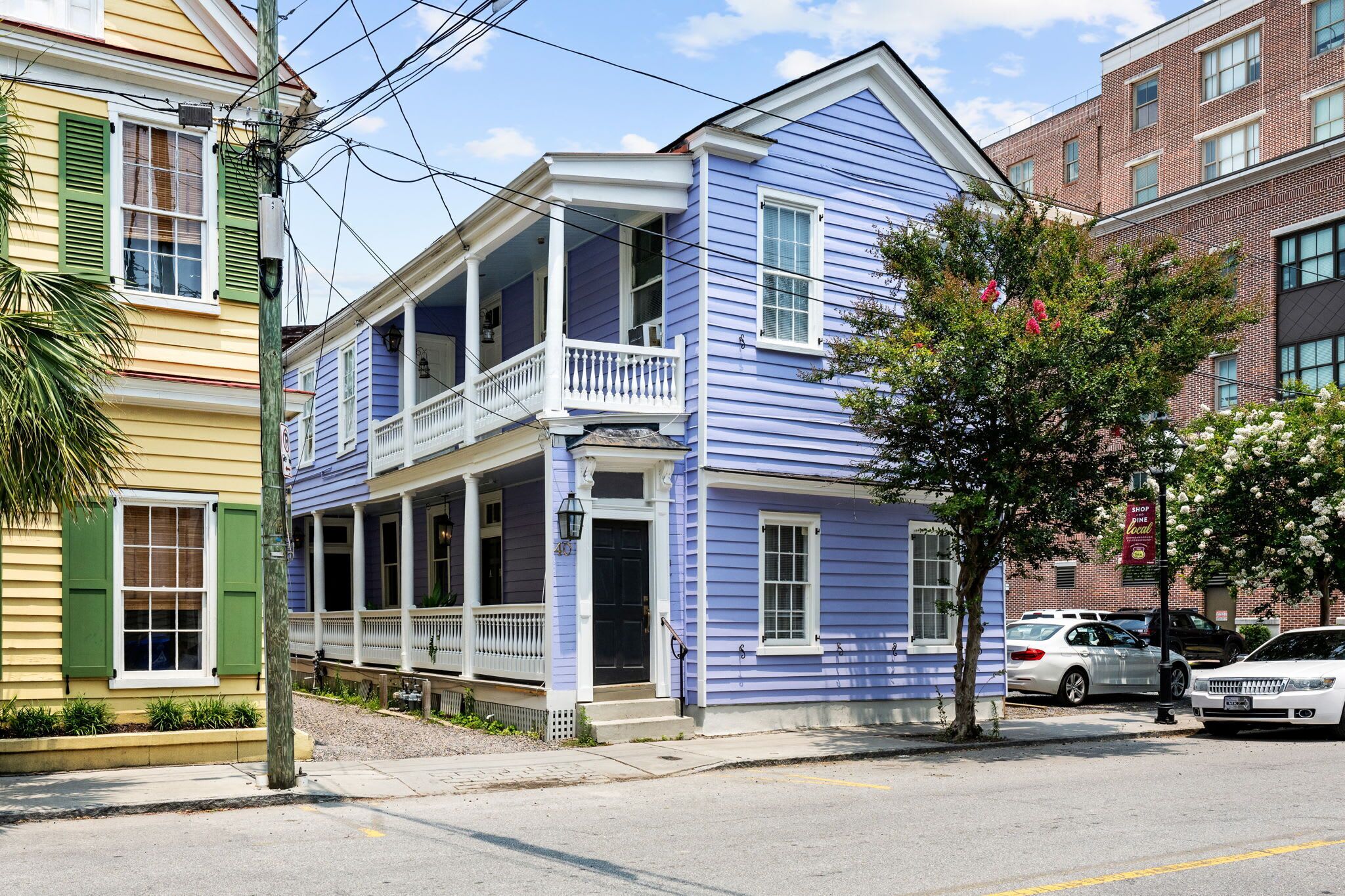 A two-story house with a balcony, a porch, and a garage.