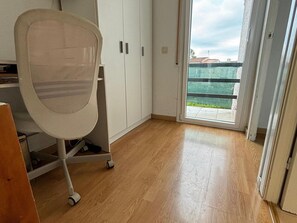 Relax in a stylish room with a comfortable office chair and ample storage in the three-door wardrobe.