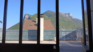 A mountain view with a building and a fenced area.