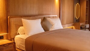 A wooden bed with a headboard, a bedside table, and a nightstand.