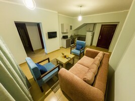 Family Apartment, 2 Bedrooms, Balcony, Pool View | Living area | 40-inch LCD TV with cable channels