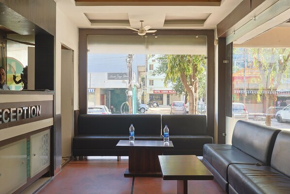 A reception area with a sofa, a table, and a reception desk.