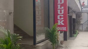 A building with a red banner reading "GOODLUCK HOUSE" and a staircase leading to the entrance. - Hotel GoodLuck House Near Delhi Airport (New Delhi)