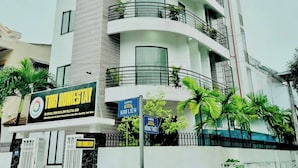 A multi-story building with balconies, a sign for 'Tori Homestay', and a gated entrance. - TORI HOMESTAY (Hue)