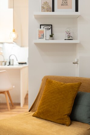 A bedroom with a bed, a bedside table, and a wall-mounted shelf with decorative items. - Loft Suite In Syntagma |Metro |Best Location (Athens)